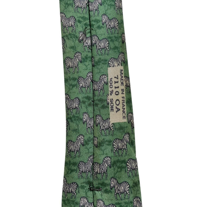 Hermes green silk tie featuring zebra print design and logo detail.