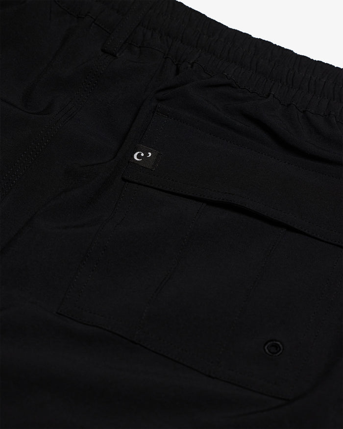 The Board Shorts in black — back pocket detail with a small logo tag and drainage eyelet