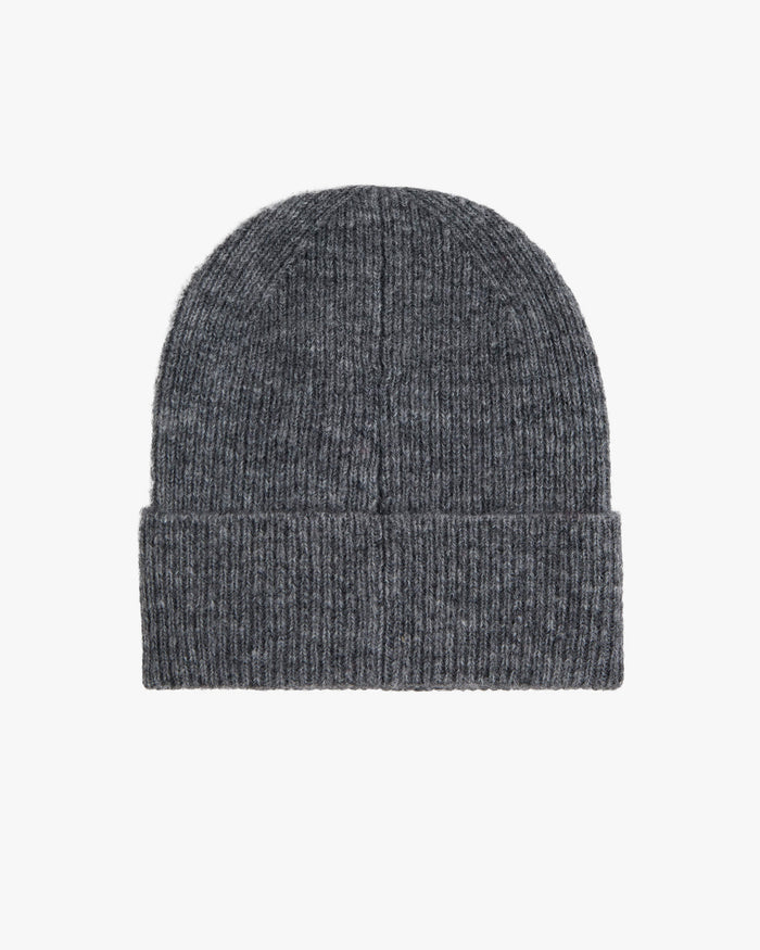 A back view of The Hairy Beanie in charcoal, laid flat on a white background. The image highlights the soft, ribbed knit texture and the folded brim.