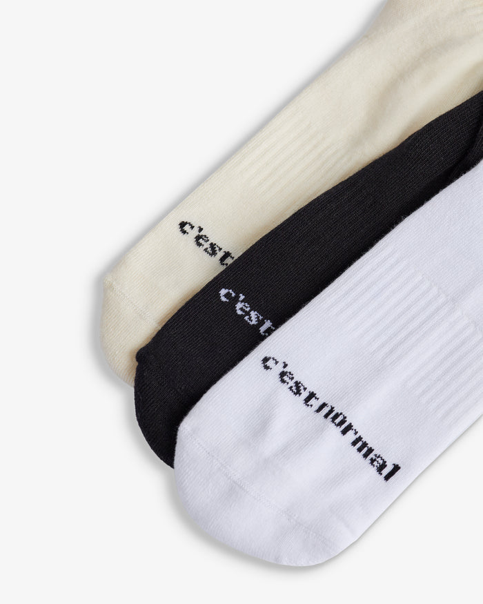 The Sock in black, white and ecru — C'est normal logo branding on the toes