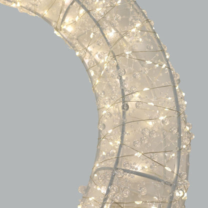 Decorative wreath with lights on a plain background