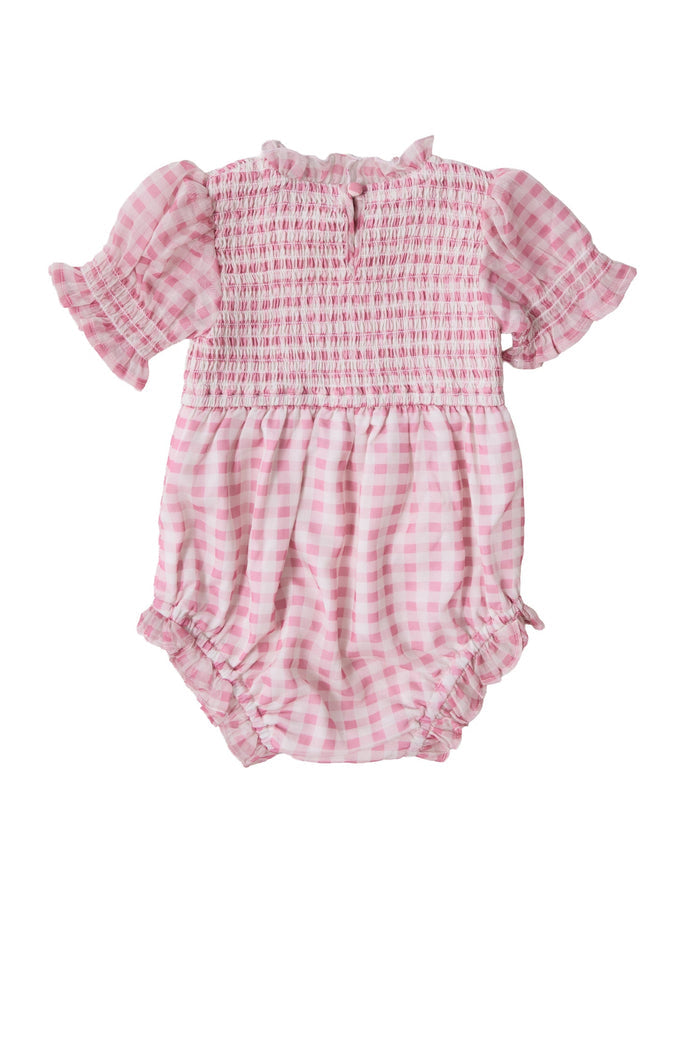 The Baby Cordelia Romper in Desert Rose Gingham by Ivy City Co features short puffed sleeves, a smocked bodice, a ruffled collar, and elastic leg openings—making this charming pink and white gingham romper perfect for sunny days.