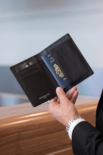 Man holding Covent Black Grain Passport Holder | Oswin Hyde