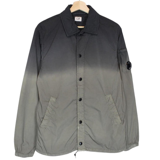 CP Company khaki green and grey jacket with shibori pattern and lens detail.
