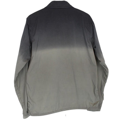 CP Company khaki green and grey jacket with shibori pattern and lens detail.