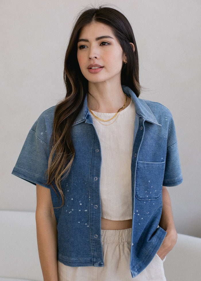 woman wearing cropped indigo short sleeve button down in vintage wash