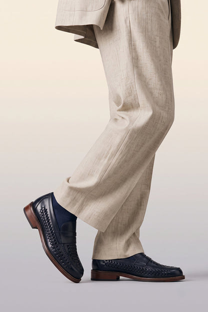 Model wearing Finley navy woven leather loafers for men, featuring premium craftsmanship, intricate weave detail, and a refined, durable finish