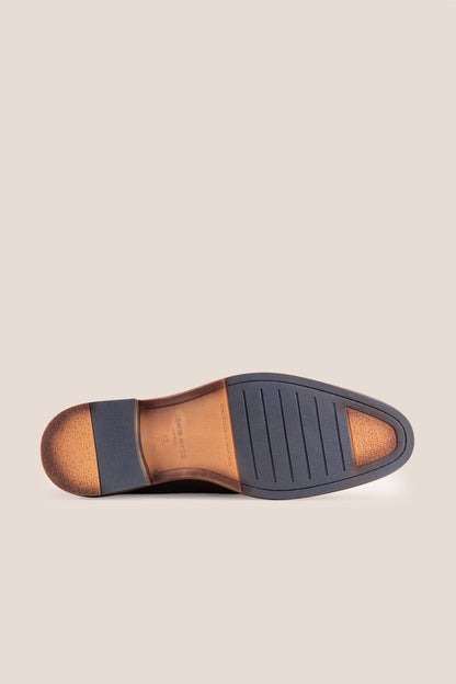 Premium brown leather tassel loafers for men featuring a textured finish, burnished moc-toe details, decorative leather tassels, and a cushioned teal interior.