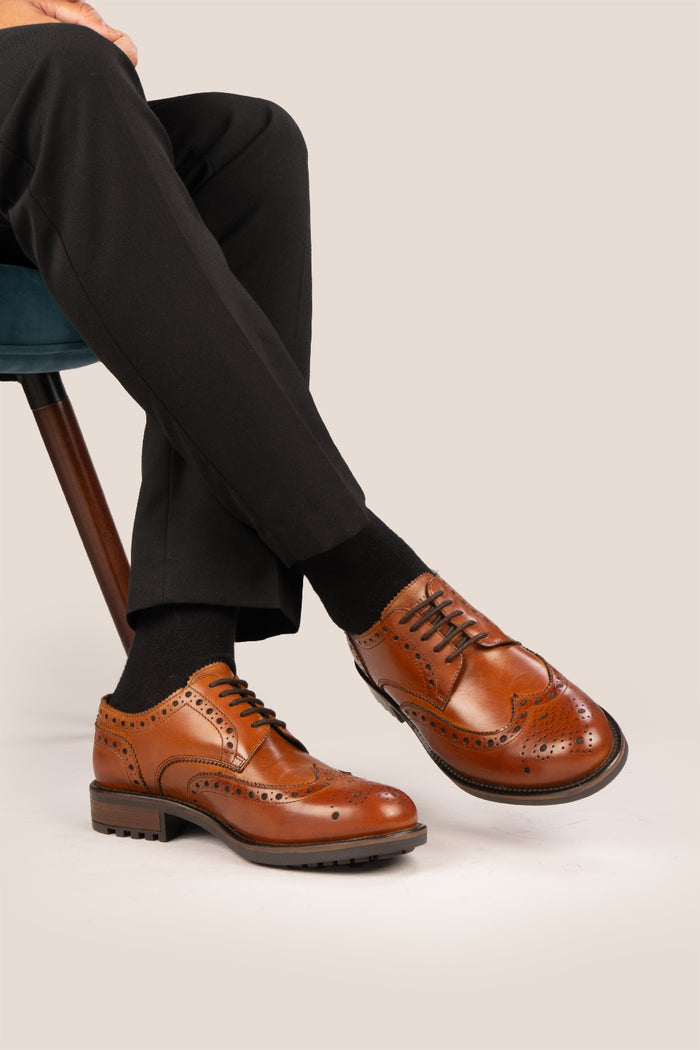 George Tan leather shoes for men. Featuring a five-eyelet wing cap brogue design, these shoes offer timeless style and comfort