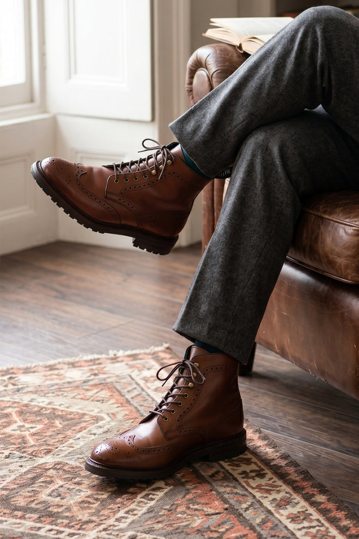 Man wearing Gregory brown leather lace-up boots for men with wing cap brogue detailing, combining refined craftsmanship and a timeless silhouette