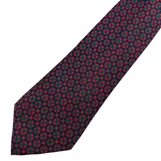 Hermes silk tie featuring geometric print in red, blue, and green colors.