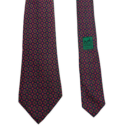 Hermes silk tie featuring geometric print in red, blue, and green colors.