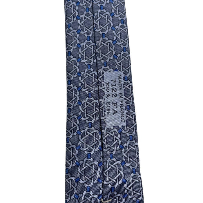 Hermes blue silk tie with geometric print and logo detail.