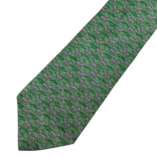 Hermes green silk tie featuring zebra print design and logo detail.