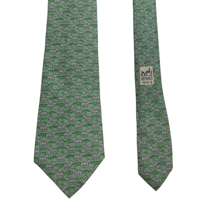 Hermes green silk tie featuring zebra print design and logo detail.