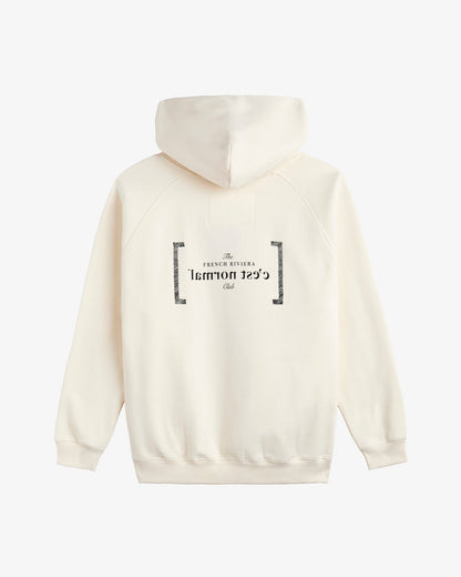 A back view of Le Hoodie in cream, laid flat on a white background. The image highlights the oversized hood, ribbed hem and cuffs, and the black FRC mirror logo and c'est normal text on the center back.