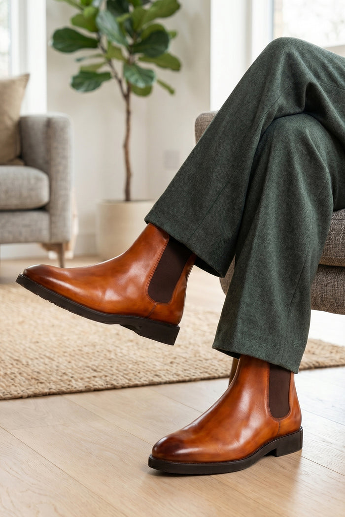 Man wearing Michael tan leather Chelsea boots for men with elastic sides and pull tab, perfect for smart-casual and formal wear.