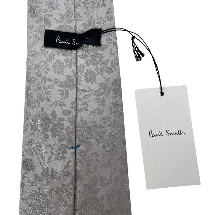 Paul Smith silver silk tie with floral print and brand logo detail.