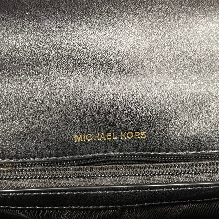 Michael Kors black duffel bag with quilted pattern and logo detail, pre-loved condition.