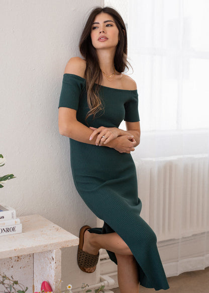 woman wearing off shoulder rib dress in courtyard green