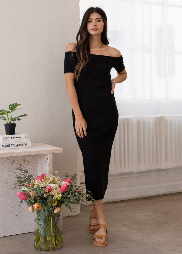woman wearing off shoulder rib dress in black
