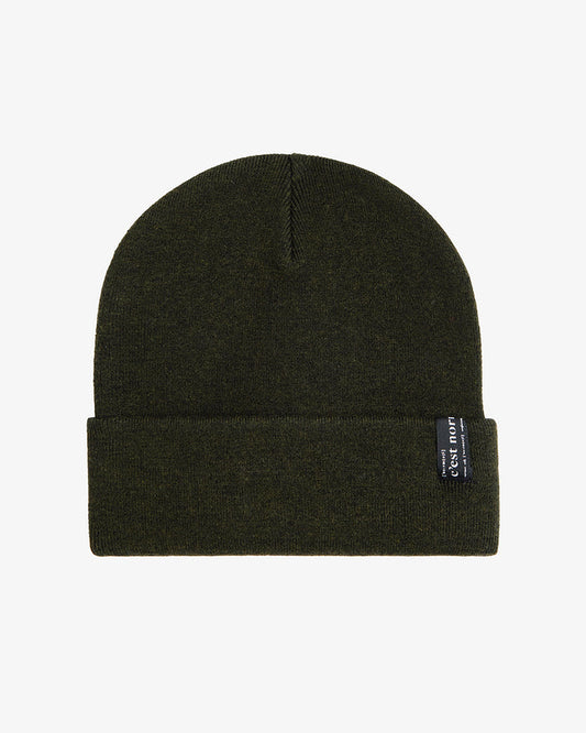 A front view of The Beanie in khaki, laid flat on a white background. The image highlights the soft fine knit, fold-over cuff, and the signature c'est normal label.