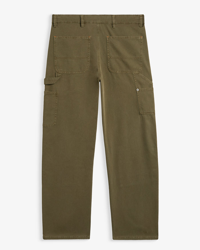 A back view of The Carpenter Pant in olive green, laid flat on a white background. The image highlights the back pockets, the hammer loop, and the copper-toned rivets. | c'est normal