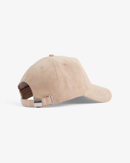 A back view of The CÔTELÉ Corduroy Cap in Irish Cream, laid flat on a white background. The image highlights the corduroy texture and the adjustable strap with a metal buckle.