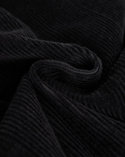 A close-up shot of the mid wale corduroy fabric of The CÔTELÉ Corduroy Straight Pants in anthracite grey, highlighting its soft, ribbed texture.