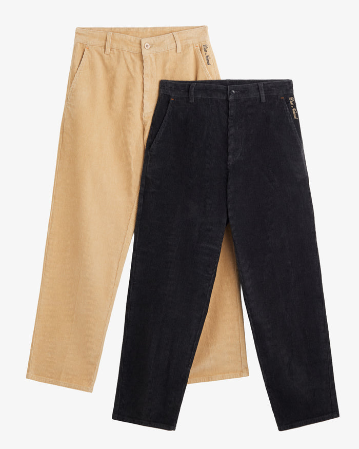 Two pairs of The CÔTELÉ Corduroy Straight Pants, laid flat on a white background. The image features a light beige pair positioned slightly behind a dark anthracite grey pair, highlighting the corduroy texture, zip fly, belt loops, and the c'est normal logo stitching at the left hip.