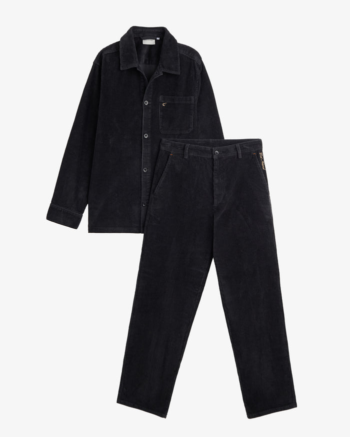 The CÔTELÉ Corduroy Straight Pants and a matching overshirt in Anthracite Grey, laid flat on a white background. The image highlights the corduroy texture, the straight leg design of the pants, and the contrast c'est normal logo stitching on the left hip.