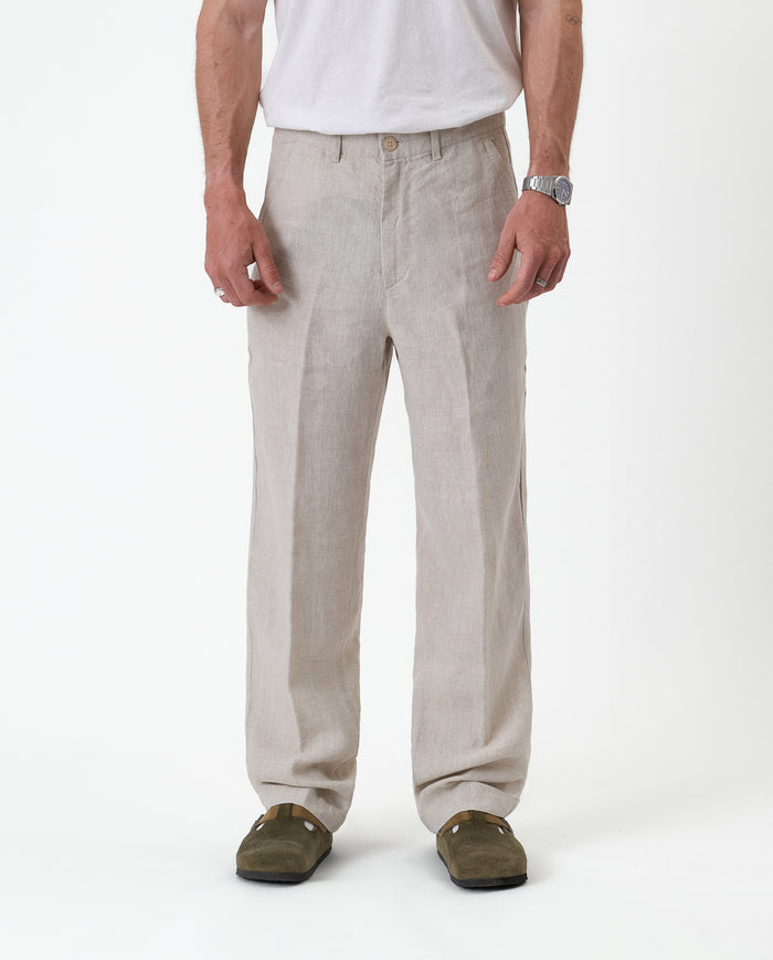 The Daily Linen Trouser in natural — front view showing the straight leg and pressed crease