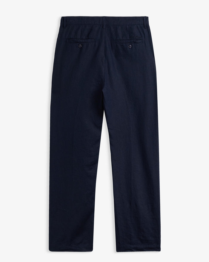 The Daily Linen Trouser in navy — back view showing functional welt pockets