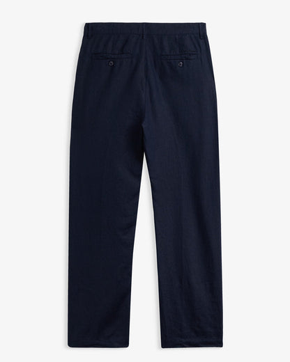 The Daily Linen Trouser in navy — back view showing functional welt pockets