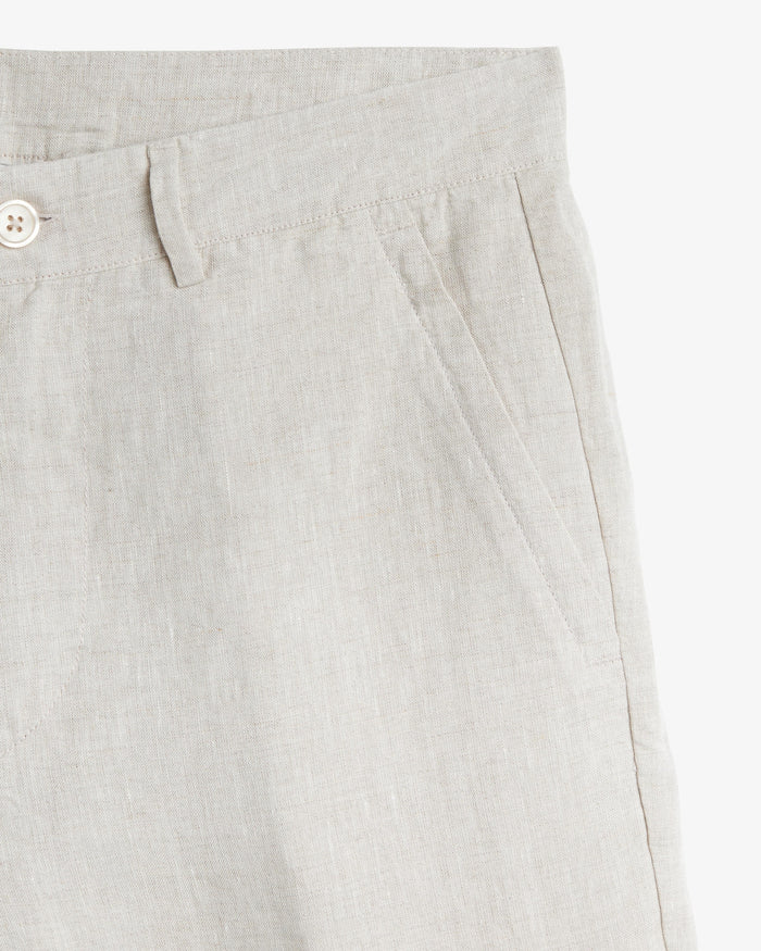 The Daily Linen Trouser in natural — close-up of the slanted front pocket and button