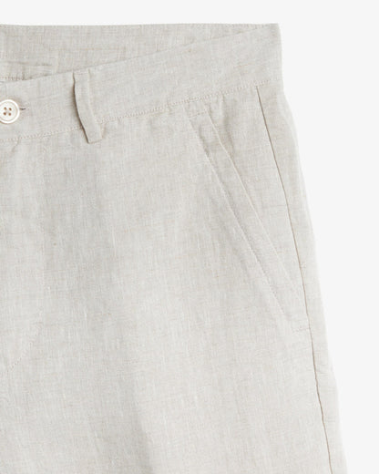 The Daily Linen Trouser in natural — close-up of the slanted front pocket and button