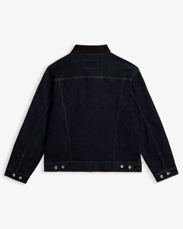 The Denim Jacket in rinse blue — back view showing the dark wash and corduroy collar