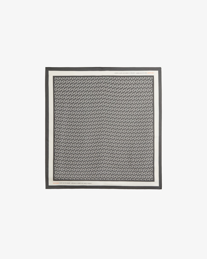 The Fall Bandana laid flat on a white background. The image highlights the signature black and cream repeating monogram print, the crisp contrast border, and the c'est normal wordmark.
