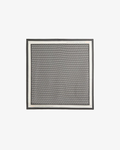 The Fall Bandana laid flat on a white background. The image highlights the signature black and cream repeating monogram print, the crisp contrast border, and the c'est normal wordmark.