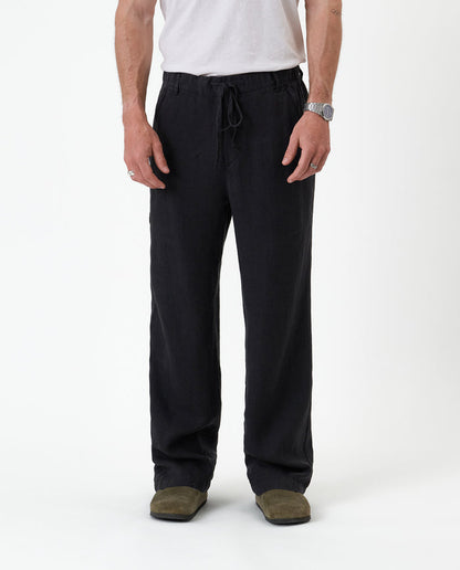 The Holiday Linen Trouser in black — front view with a drawstring waist