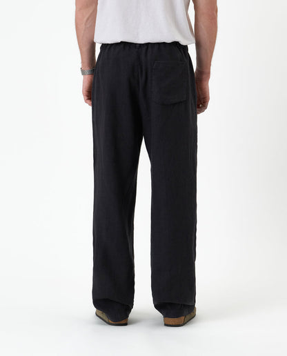 The Holiday Linen Trouser in black — back view against a white background