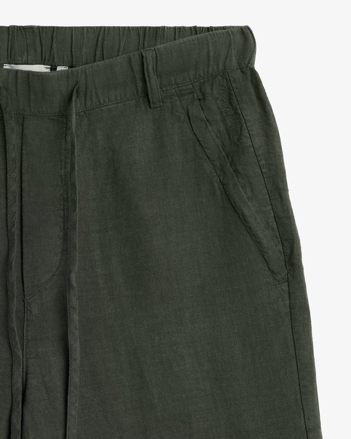 The Holiday Linen Trouser in dark khaki — close-up of the elasticated waistband and pocket