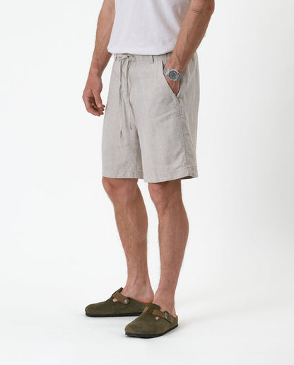 The Holiday Linen Short in natural — side view worn with green suede clogs