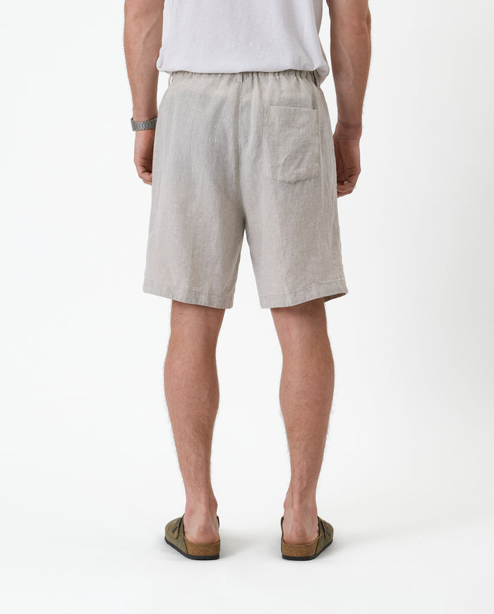 The Holiday Linen Short in natural — back view showing the single rear pocket