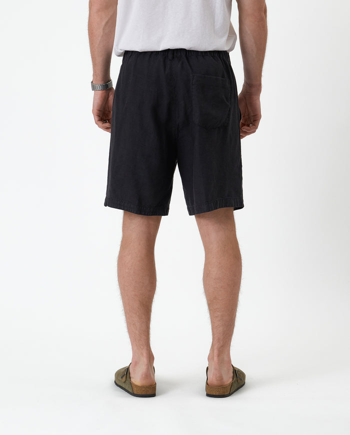 The Holiday Linen Short in black — back view showing the elasticated waistband and pocket