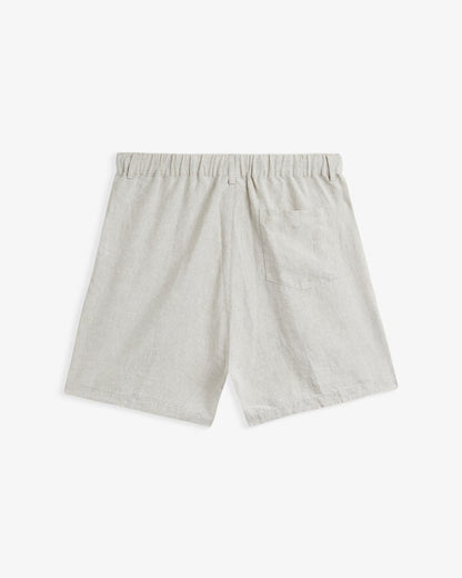 The Holiday Linen Short in natural — back view showing the rear pocket