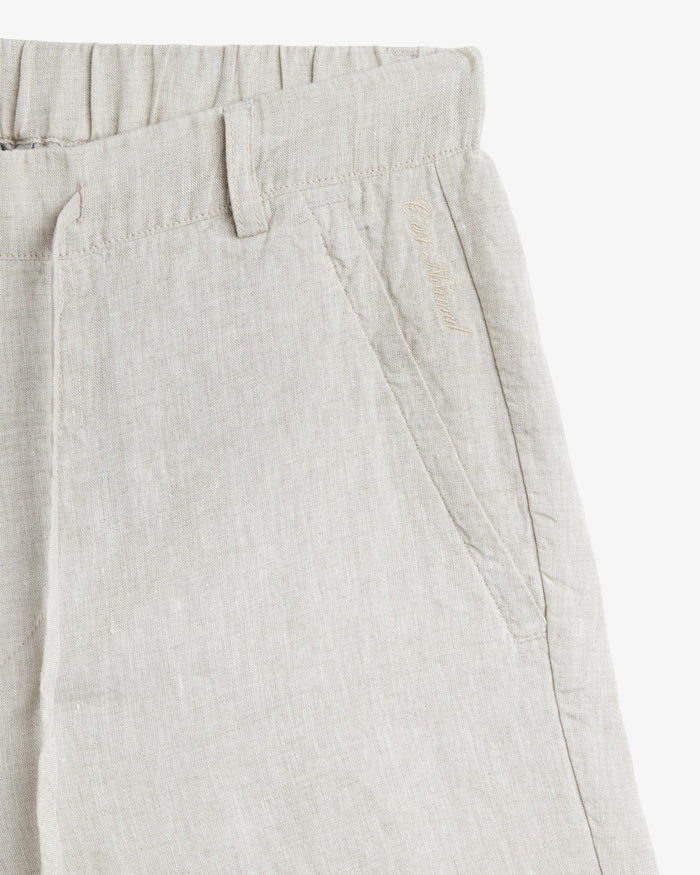 The Holiday Linen Short in natural — featuring tonal C'est normal embroidery near the pocket