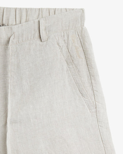 The Holiday Linen Short in natural — featuring tonal C'est normal embroidery near the pocket