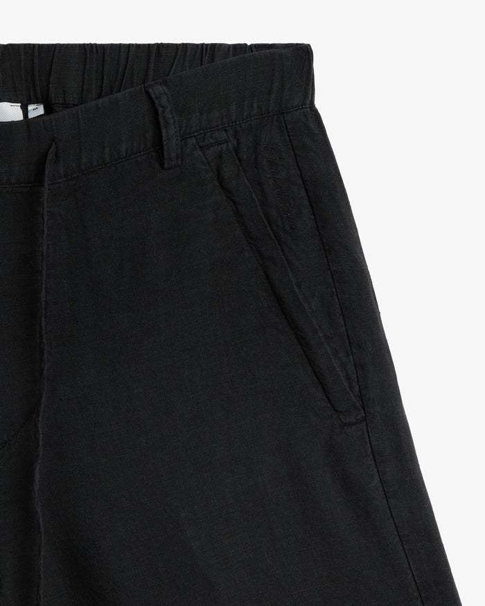 The Holiday Linen Short in black — close-up of the side pocket with tonal embroidery