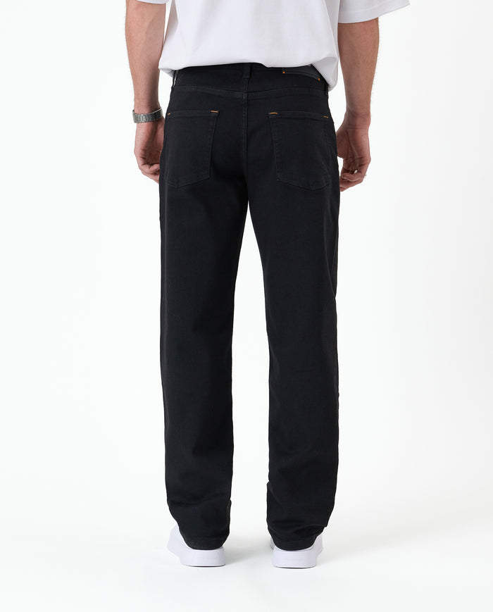 The Jeans Relaxed Straight Fit in Jet Black — back view showing the straight leg silhouette